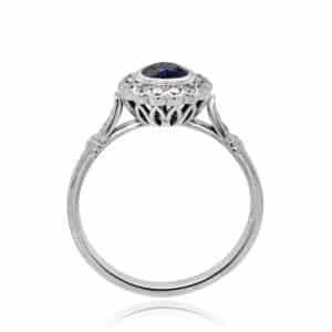Delicate Art Deco-inspired petite sapphire ring featuring a round blue sapphire, set in an intricate vintage-style band | OroSpot | Chicago, Illinois