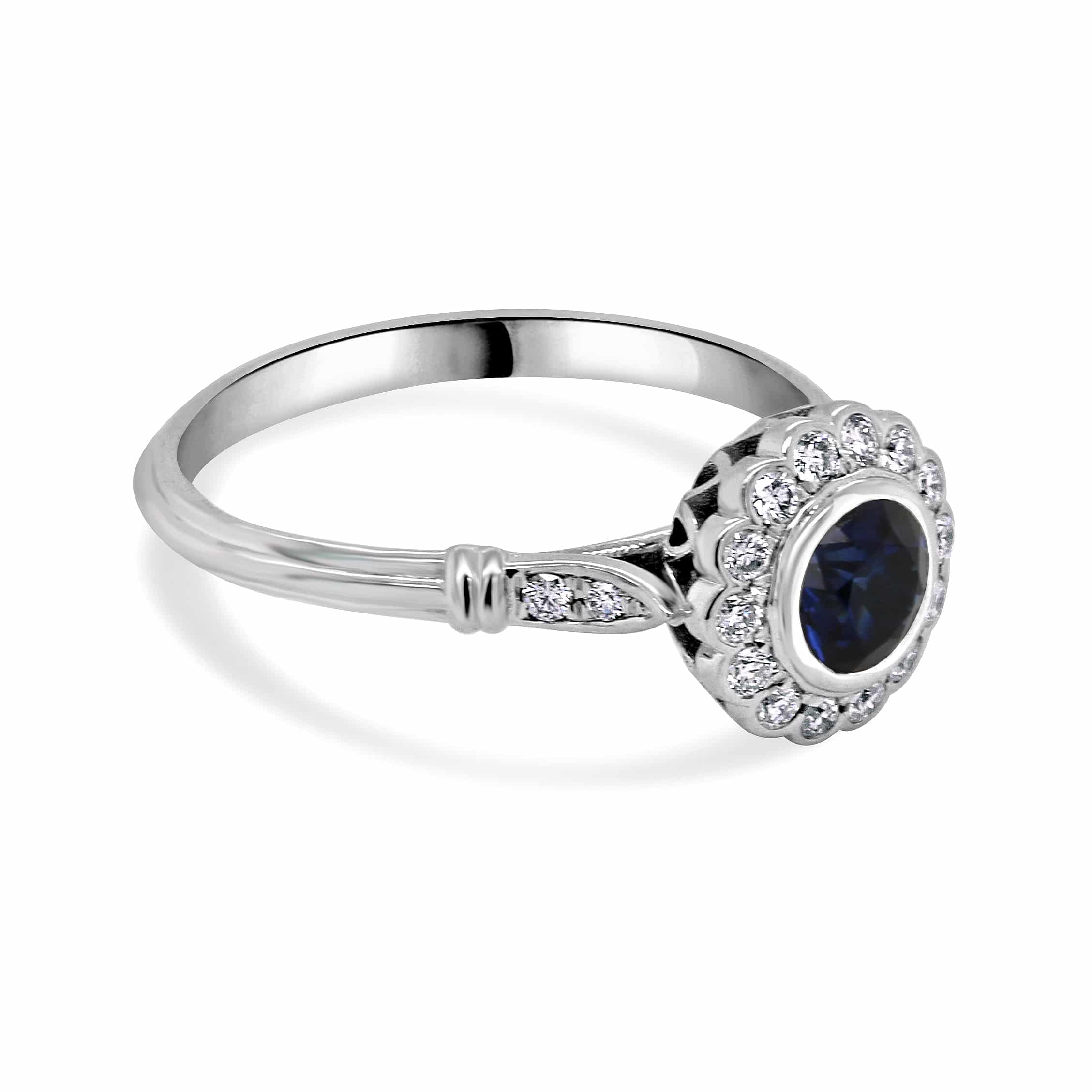 Vintage-inspired diamond halo sapphire ring featuring a stunning round blue sapphire, encircled by a shimmering diamond halo in an elegant setting | OroSpot | Chicago, Illinois
