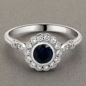 art deco round blue sapphire engagement ring with bezel set sapphire floral diamond halo and pavé band in 14k white gold orospot