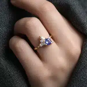 minimalist tanzanite ring with baguette moissanites, diamond accents, satin finish, and slim yellow gold band