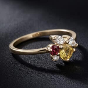 Delicate yellow gold promise ring with mixed gemstones including sapphire, ruby, and diamonds.