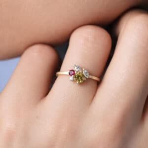 Stackable yellow gold ring with ruby, marquise diamonds, round diamond, and yellow sapphire accents.