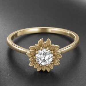 Angled view of a yellow gold sunflower engagement ring with a rose cut natural diamond.