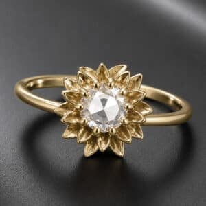 Sunflower-inspired engagement ring featuring a natural rose cut diamond surrounded by textured gold petals.