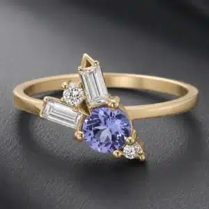 14k yellow gold tanzanite engagement ring with baguette moissanites and diamond cluster accents in a delicate modern design