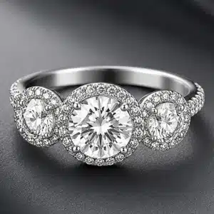 Three halo engagement ring featuring three round lab-grown diamonds surrounded by natural diamond halos in 14K white gold.