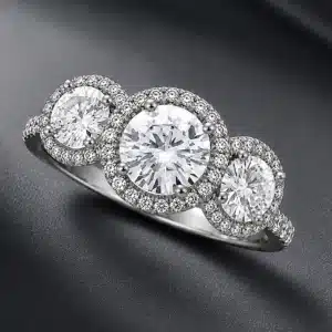 Three stone halo diamond engagement ring with micro-pavé natural diamonds and round lab-grown center stones.