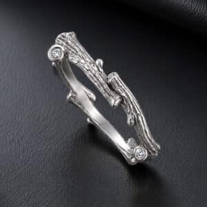 14K gold tree twig bark wedding ring with organic branch texture and burnish-set round diamonds.