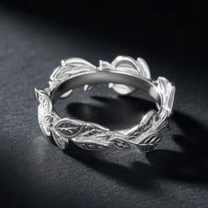 14K white gold vine leaf wedding band with hand-carved leaves, twig details, and a matte finish.