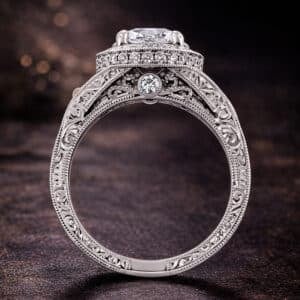 Vintage halo engagement ring with hand engraving, milgrain, and a detailed antique-inspired