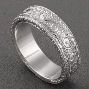 mens hand engraved wedding band with geometric art deco pattern and detailed engraving