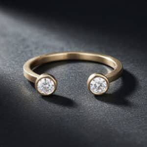 Open 14K gold ring with two bezel-set round lab diamonds and a minimalist flat shank design.