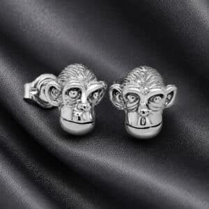 Small chimpanzee head stud earrings in polished white gold with detailed animal face design.