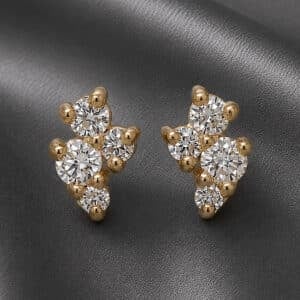 14K yellow gold diamond cluster stud earrings displayed on dark metallic grey satin fabric background.