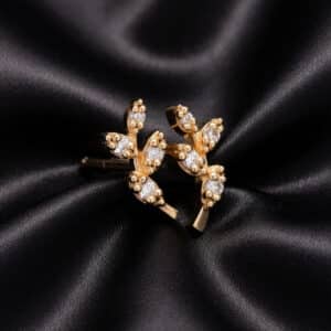 Minimalist olive branch earrings in solid yellow gold with prong-set diamonds and climbing leaf design.