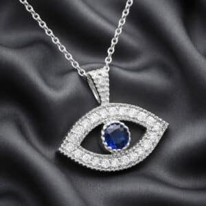 14K white gold evil eye necklace with blue sapphire center and diamond accents handcrafted by OroSpot.