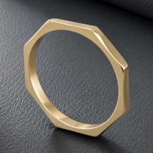 Modern geometric wedding band featuring an eight-sided polygon design, clean lines, and a slim stackable profile in solid gold.
