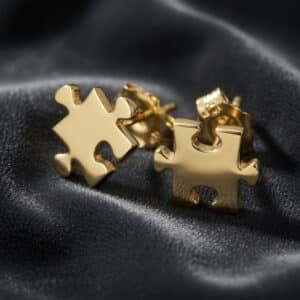 Minimalist 14K yellow gold puzzle piece stud earrings with polished finish and symbolic modern design by OroSpot
