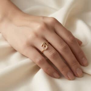 Minimalist OM symbol ring in polished 14K gold inspired by Hindu and Buddhist spiritual traditions.