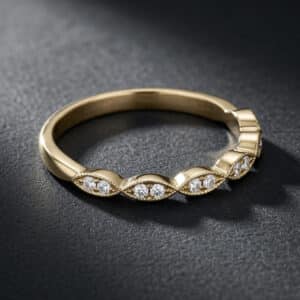 14K white gold wedding band with round diamonds set in marquise-shaped settings, featuring delicate milgrain detailing and a slim profile.
