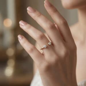 Minimalist 14K yellow gold stacking ring with two round bezel-set lab diamonds and open design.