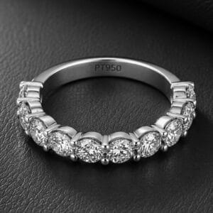 Platinum wedding ring featuring ten shared-prong diamonds set halfway around the band with a high-polish finish and modern design.