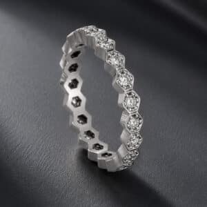14K white gold hexagon diamond eternity band with round diamonds, milgrain edges, and geometric design.