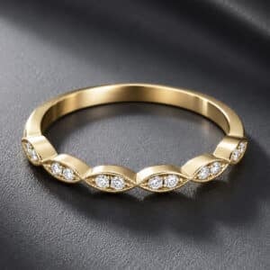 Modern wedding band featuring pairs of round diamonds set within marquise-shaped sections, accented by milgrain edges and a high-polish finish.