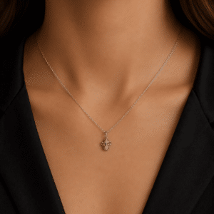 Woman wearing a small monkey head pendant necklace in 14K white gold by OroSpot.