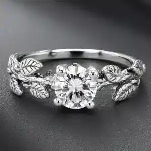 Nature-inspired engagement ring with a certified round lab-grown diamond and sculpted leaf details in white gold.