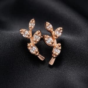 14K yellow gold olive branch climber earrings with small leaf details and round natural diamonds.