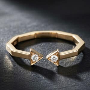Modern open arrow diamond ring in 14K yellow gold featuring two round diamonds, geometric lines, and a sleek minimalist design.