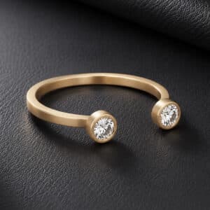 14K yellow gold open minimalist diamond ring with two bezel-set round lab diamonds and satin matte finish.