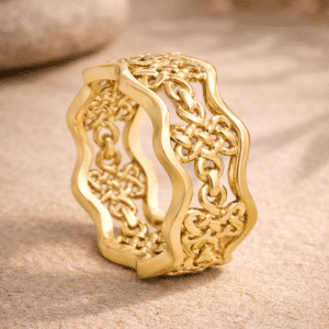 tibetan endless knot men's wedding band in yellow gold on a zen stone background symbolizing unity and eternity handcrafted by orospot