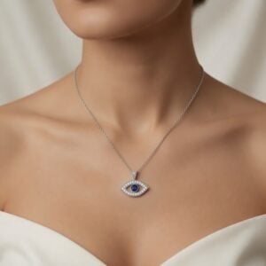 Woman wearing a 14K white gold evil eye necklace with blue sapphire center and diamond accents by OroSpot.