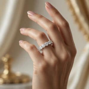 Woman wearing a wide 14K white gold eternity band with round lab-grown diamonds in a shared-prong setting.