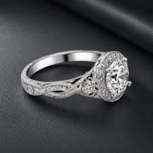 Vintage engagement ring featuring a round lab-grown diamond, diamond halo, milgrain details, and engraved split shank.
