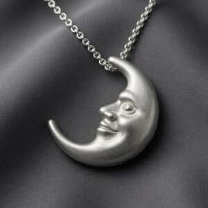 Reversible crescent moon necklace with happy and sad moon faces by OroSpot.