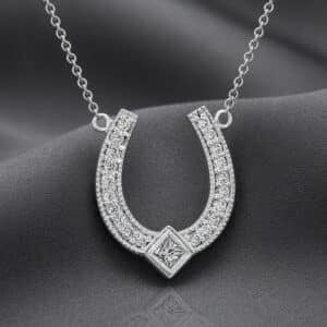Diamond horseshoe pendant in 14K white gold with round and princess-cut diamonds by OroSpot.