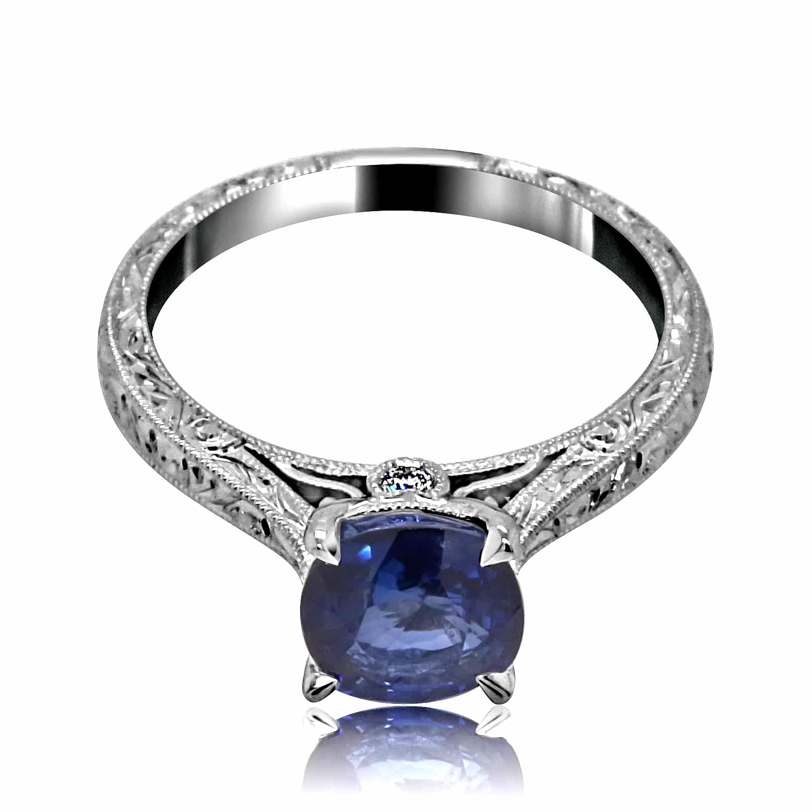 Antique sapphire engagement ring with 1.51ct cushion-cut blue sapphire in 14K white gold, hand engraved and rhodium finished.