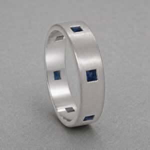 square sapphire channel set mens wedding band close up white gold satin finish orospot