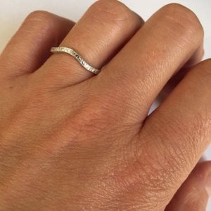 Engraved curved band on hand