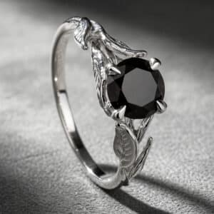 Nature-inspired black diamond engagement ring with leaf detailing in 14K white gold by OroSpot.