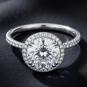Modern halo engagement ring featuring a 3ct round lab-grown diamond surrounded by a natural diamond halo and pavé diamond band.