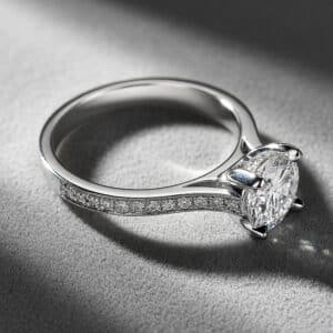 Modern lab diamond engagement ring with pavé band and four-prong setting by OroSpot.