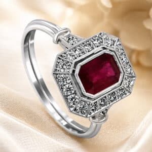 art deco ruby halo engagement ring with octagon cut ruby center, diamond halo, milgrain detail, vintage inspired white gold orospot