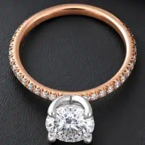 Modern dainty engagement ring featuring a certified 1.5ct round lab-grown diamond, platinum basket, 14K rose gold shank, and pavé natural diamonds.