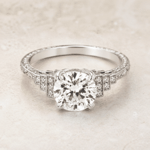 art deco step diamond engagement ring with 2 carat round lab diamond, pave shoulders and geometric vintage design in white gold orospot