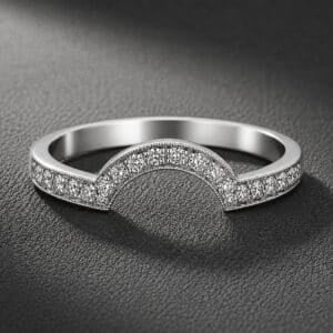 Pavé diamond contour wedding band with a curved profile, high-polish finish, and modern minimalist styling.