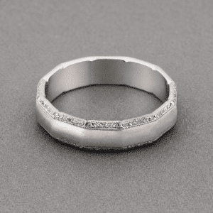 Top view of dodecagon men’s wedding band with engraved vintage pattern and milgrain edges by OroSpot